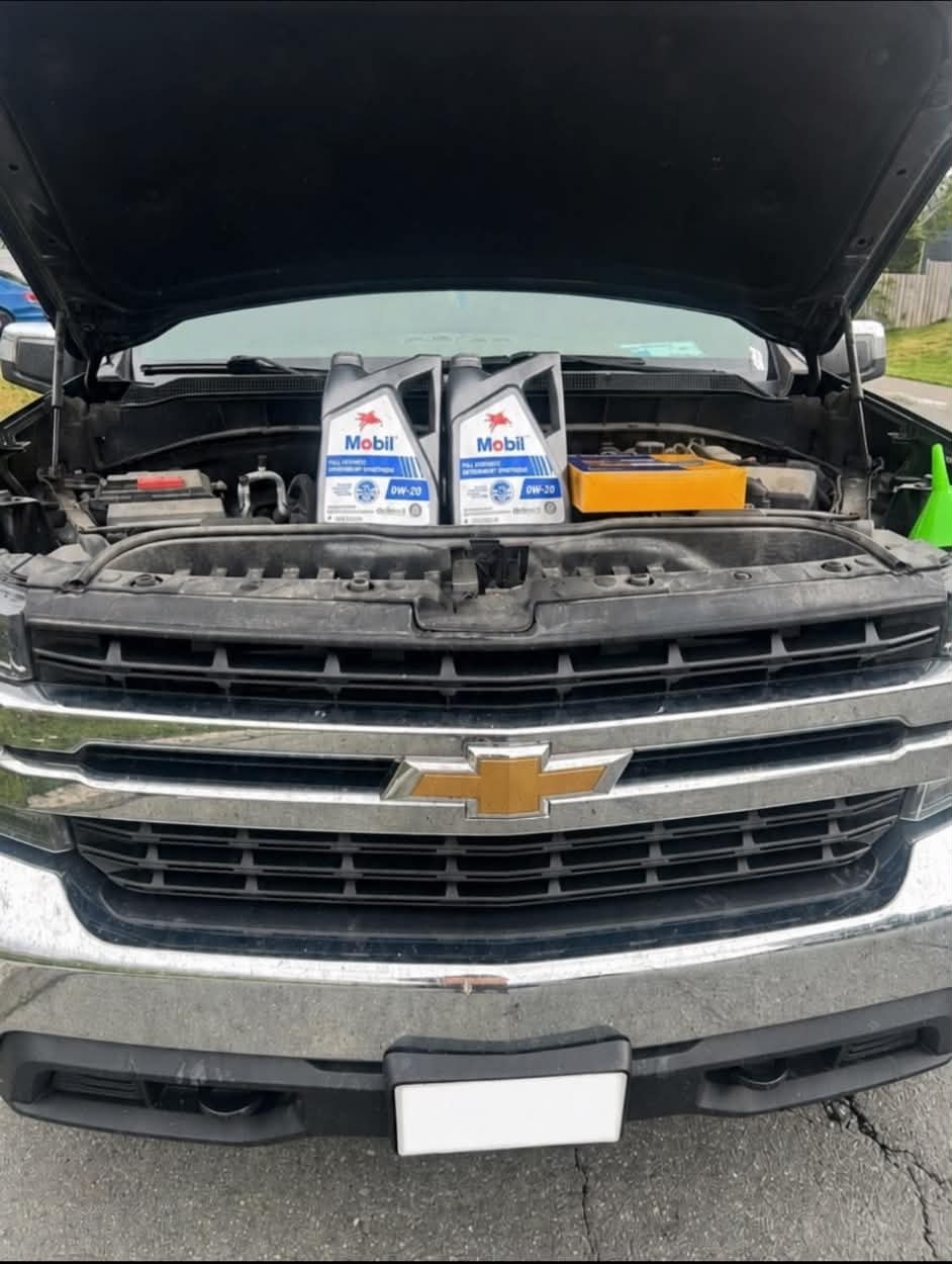Open engine bay with maintenance fluids visible